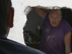 Neighbors stare at each other through a hole in a shared wall of their apartments.