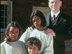 Australian official poses with children in film.