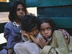 The three Aboriginal children ride in the back of a truck.